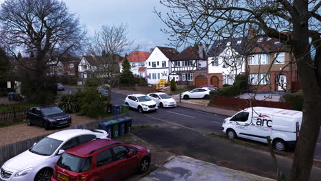 A-typical-street-in-Harrow,-London,-UK,-with-houses-and-cars-parked-and-moving
