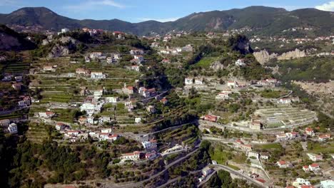 Italian-Amalfi-coastline-terraces-in-the-town-of-San-Michele-with-homes-and-buildings-on-the-ravine,-Aerial-drone-dolly-out-reveal-shot