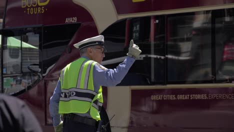 Old-NYPD-traffic-officer-directing-traffic-in-Downtown-Manhattan-on-a-hot-summer-day,-filmed-in-180fps