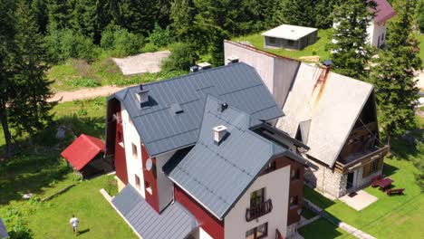 Modern-built-home-with-a-weatherproof-roof-near-the-Lasva-River,-Aerial-dolly-out-shot
