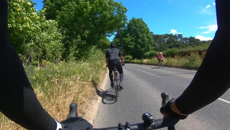POV-Following-Cyclist-On-Road-In-Amersham-With-Cars-Overtaking