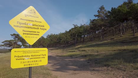 Pribaikalsky-National-Park-sign-with-forest-background,-camera-pan