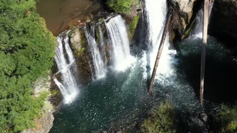 Drone-footage,-still,-looking-down-at-multiple-water-falls-flowing-at-Coquille-falls