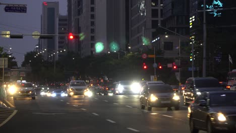 Many-cars-passing-by-at-a-multilane-crossroads-at-Gangnam-station,-Seoul,-South-Korea