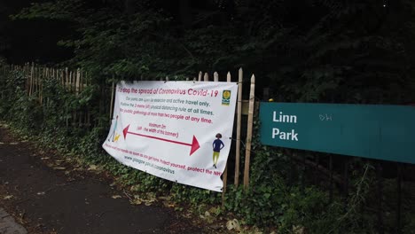 A-side-view-of-a-Coronavirus-health-poster-outside-a-Glasgow-public-park