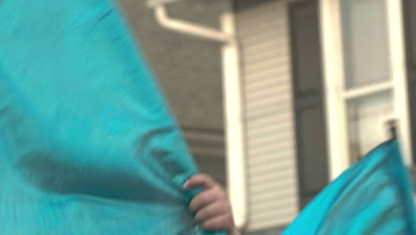 Young-girl-in-color-guard-marching-in-small-town-parade-in-Pennsylvania,-Close,-Slow-Motion