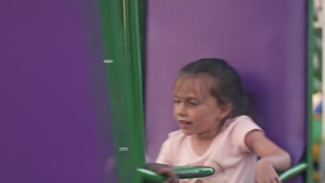 Kids-looking-sick-while-spinning-on-carnival-ride,-Close-Up