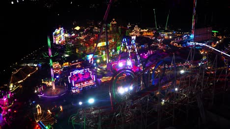 drone-shot-of-the-theme-park-Winter-Wonderland-in-Hady-park-in-London,-United-Kingdom-at-night