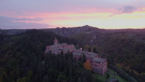 Abbey-of-Monte-Oliveto-Maggiore-during-magical-bright-sunrise,-aerial