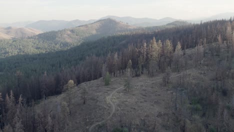 Aerial-of-hiking-trail-with-wildfire-smoke-in-the-valley