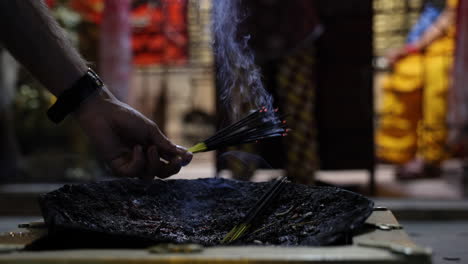 Worshipper-places-burning-incense-at-a-temple
