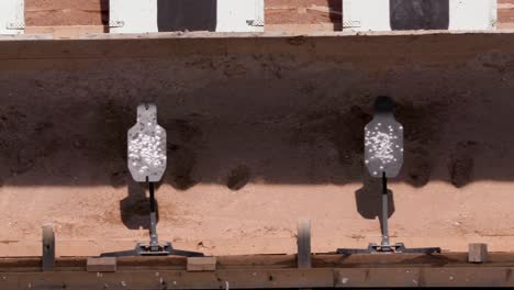 Bullets-hit-metal-target-in-shooting-range,-closeup,-slow-motion