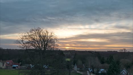 Time-lapse-of-fast-moving-clouds-and-a-treeline-silhouette,-Thetford,-Norfolk,-England