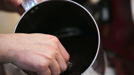 Barista-mixing-coffee-ground-traditional-by-hand
