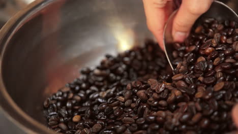 Barista-hand-mixing-coffee-beans-professionally