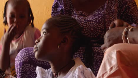 Two-black-women-make-braids-with-the-hair-of-a-girl