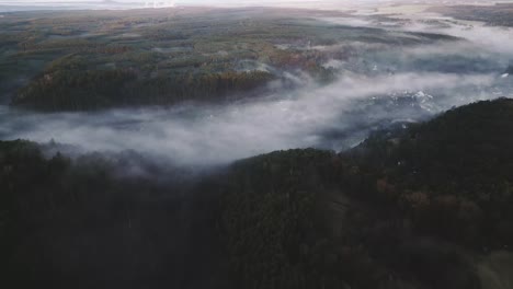Aerial-drone-view-of-morning-mist-or-fog-in-Czech-Republic-village,-forest-panorama