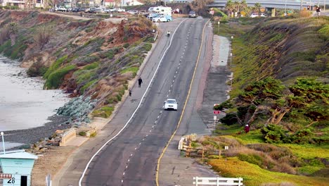 telescopic-view-of-a-car-driving-down-pch-highway-Carlsbad