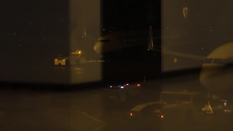 Ryanair-Boeing-plane-taxiing-for-runway-for-take-off,-view-from-inside-airport