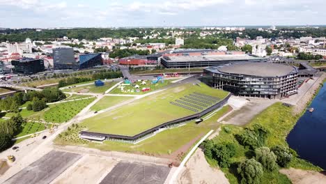New-modern-pool-building-near-Zarligis-arena-in-Kaunas-city,-aerial-orbti-view