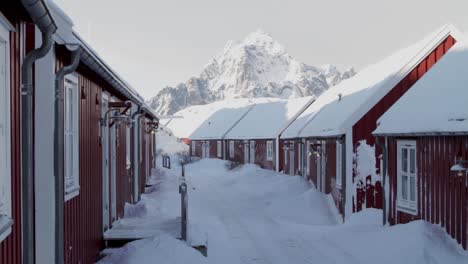 Fixed-shot-of-a-beautiful-landscape-with-red-bungalows-in-Svolvar,-Lofoten-Islands-on-a-sunny-and-snowy-day