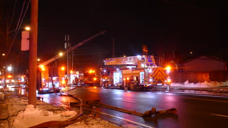 Firefighters-extinguish-fire-late-at-night-in-the-snowy-winter