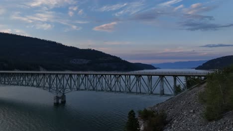 Koocanusa-Bridge-And-Tranquil-Lake-In-Rexford,-Montana,-United-States---aerial-drone-shot