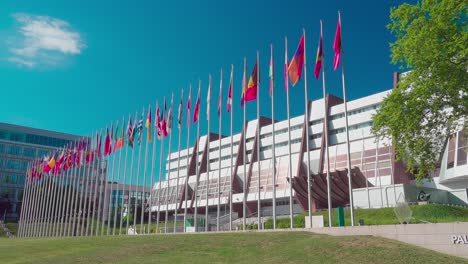 This-is-a-closeup-of-the-front-of-the-European-Council-and-a-row-of-flags-in-Strasbourg,-Alsace,-France