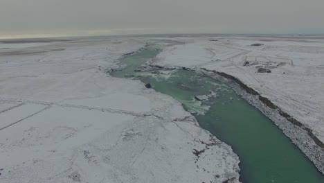 Iceland-in-winter-flying-over-river-and-canyon-Drone-4K