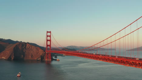 Dolly-back-revealing-aerial-shot-of-the-golden-gate-bridge-at-sunset