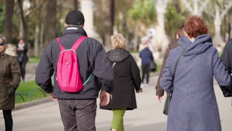 Person-with-pink-backpack-in-Barcelona-streets,-slow-motion-view