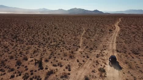 Off-road-vehicle-drives-across-Mojave-Desert,-Utah