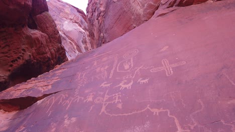 Gimbal-close-up-panning-shot-o-ancient-petroglyphs-carved-into-the-sandstone-rock-in-Valley-of-Fire,-Nevada