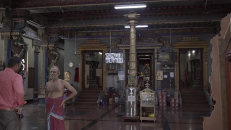 Mahe-Seychelles-inside-the-hindu-temple,-men-talking-and-laughing,-the-only-hindu-temple-in-Seychelles,-built-in-1999,-located-on-Mahe