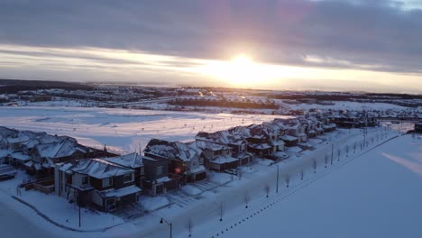 Aerial-view-of-a-suburban-community-at-sunset-in-Calgary,-Alberta-in-winter