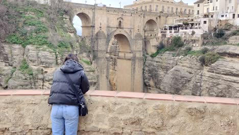 Tracking-shot-of-a-tourist-looking-at-the-stunning-architecture-at-Ronda,-Spain
