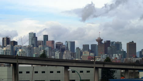 Expo-Line-Skytrain-Fährt-Auf-Erhöhten-Führungswegen-Mit-Skyline-Der-Innenstadt-Von-Vancouver-Im-Hintergrund-In-Vancouver,-Britisch-Kolumbien,-Kanada