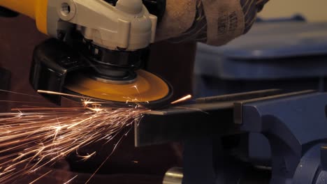 Using-an-angle-grinder-to-smooth-out-a-cut-in-angle-iron---close-up-slow-motion