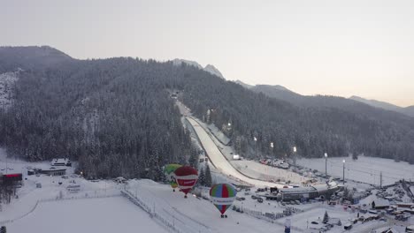 Sunset-at-Ski-Jump-in-Zakopane-with-hot-air-balloons-during-winter-season