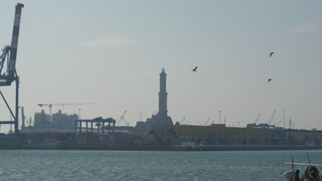 Lanterna-lighthouse-in-Genoa-port-and-boats-ships-passing