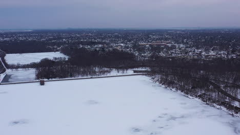 An-aerial-view-from-a-drone,-over-a-lake-during-sunrise-on-a-cloudy-morning