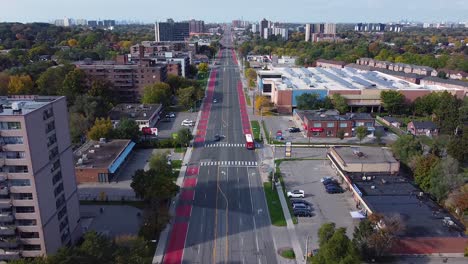 Toronto-buses-driving-in-bus-lanes-on-Eglinton-Avenue-picking-up-passengers-at-bus-stops