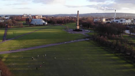 Static-shot-of-people-playing-sport-on-Glasgow-Green-in-Glasgow,-Scotland