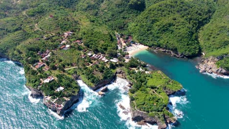 Tropical-fishing-village-on-cliffs-and-small-port-cove,-Gesing,-Indonesia-aerial