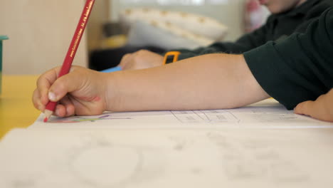 CLOSE-UP-Young-School-Students-Coloring-In-Work-At-Class-Desk,-SLOW-MOTION