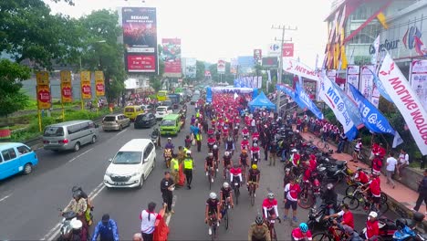 Rolling-start-of-urban-bicycle-road-race-in-Magelang,-Indonesia,-aerial-view