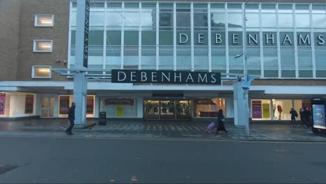 People-Walking-Past-Closed-Debenhams-Store-In-The-High-Street-In-London