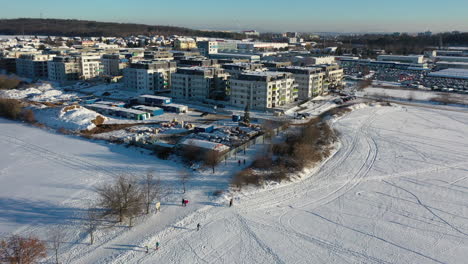 Aerial-view-of-Zlicin-snow-capped-residential-buildings-at-winter,-suburban-area-of-Prague,-Czech-Republic,-drone-shot