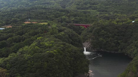 Toroki-Falls,-Pan-Over-Yakushima-Island-Aerial-of-Forest,-Waterfall-and-Bridge