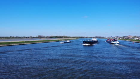 Shipping-Vessels-Meet-At-Noord-River-Loaded-With-Goods-Near-Hendrik-Ido-Ambacht,-Netherlands